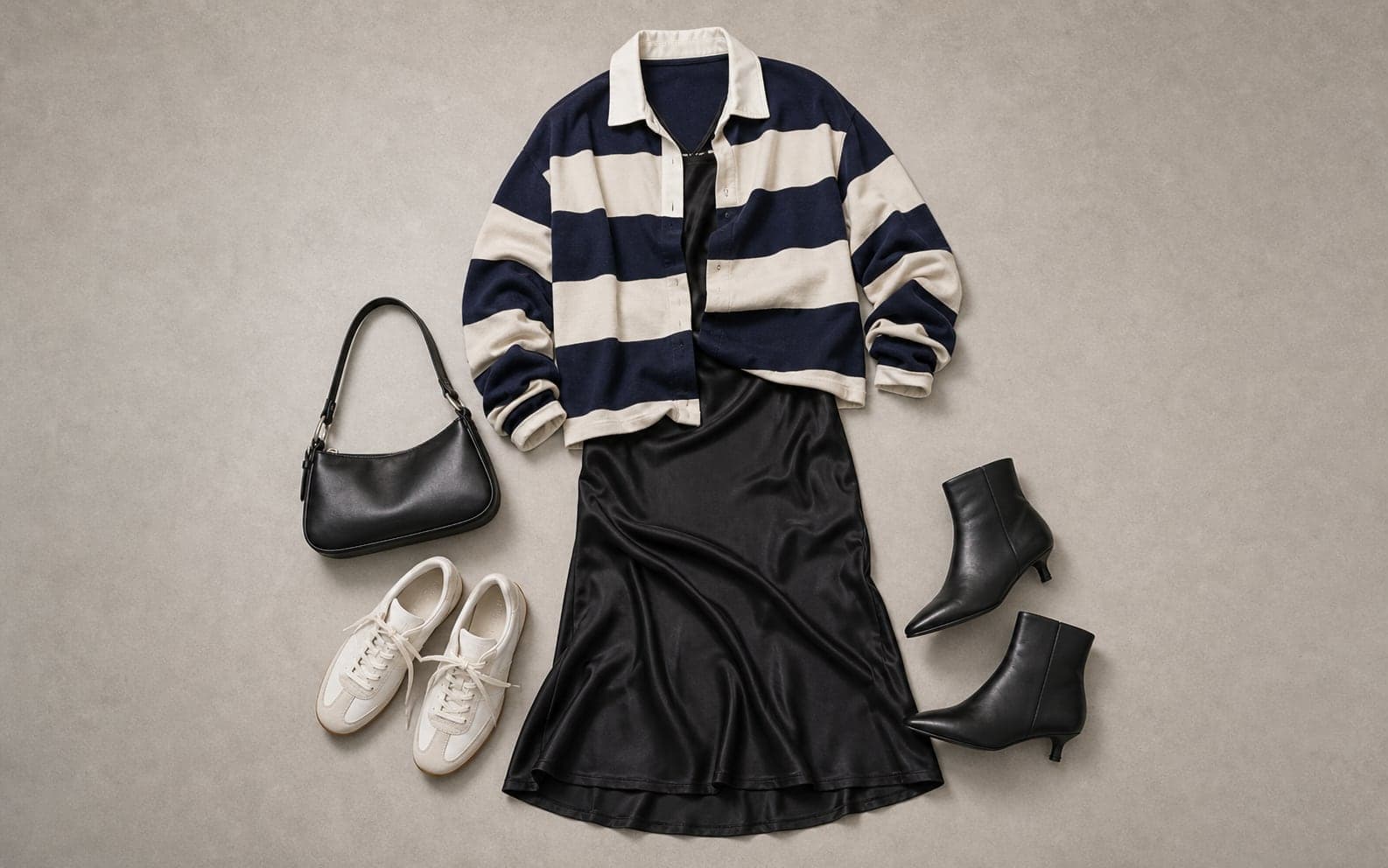 A complete outfit with a navy striped rugby shirt layered over a black slip dress, sneakers, boots, and a small black bag.