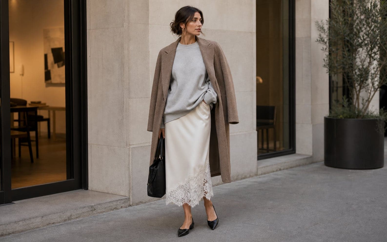 A lace-trim midi skirt with a clean oversized grey sweatshirt, pointed flats, and a structured coat.